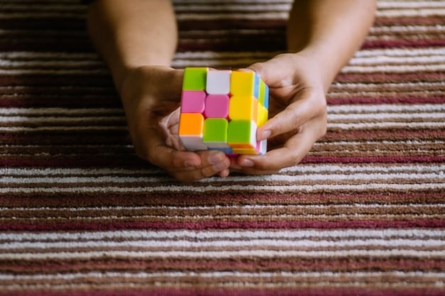 A close-up shot of a child's hands playing with wooden blocks on a colorful rug. The blocks are arranged in various shapes and sizes, showing the child's creativity and imagination. The background is blurred to focus on the child's hands and the blocks.
