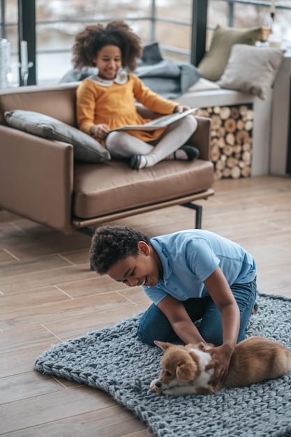 A young boy in elementary school carefully vacuuming the living room floor, with his pet dog lying nearby. The scene is set in a cozy and well-maintained home.