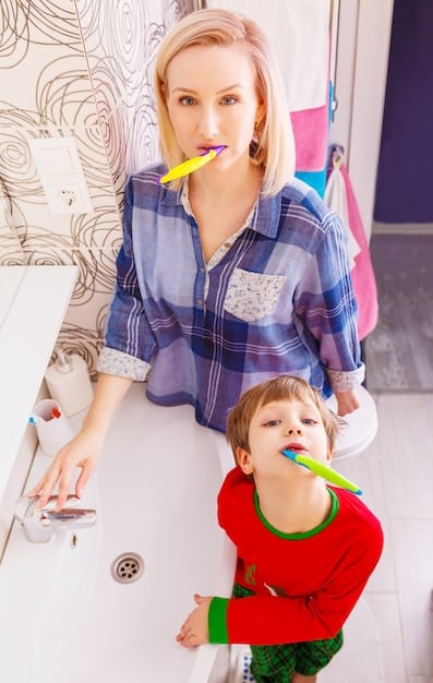 A parent and child high-fiving next to a potty chair, both smiling. The bathroom is decorated with colorful posters and a small basket of toys sits nearby.
