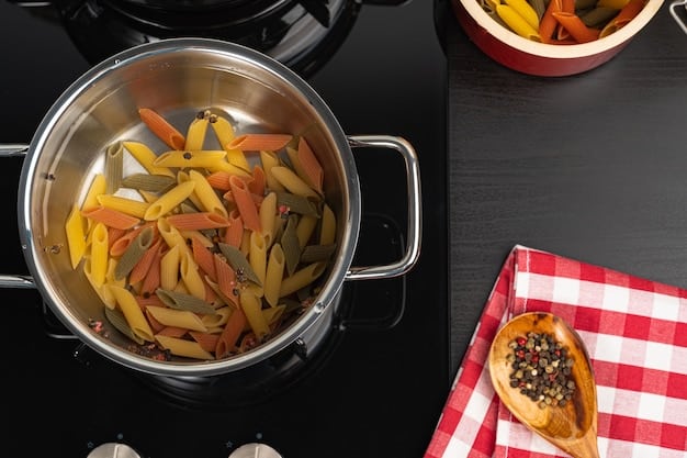 An overhead shot of a large pot of spaghetti sauce simmering on the stove. Various chopped vegetables (carrots, zucchini, and onions) are visible being stirred into the sauce. The focus is on the sauce and vegetables.