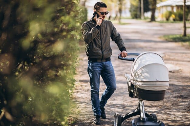A father is pushing a stroller with his baby in a park. He is singing a song to his baby, who is looking up at him with a smile. The park is green and sunny, with trees and flowers in the background. There are other people in the park, but the focus is on the father and baby's musical interaction.