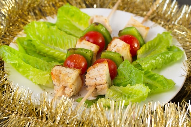 A colorful arrangement of grilled chicken and vegetable skewers on a plate, featuring bite-sized pieces of chicken, bell peppers, cherry tomatoes, and zucchini.