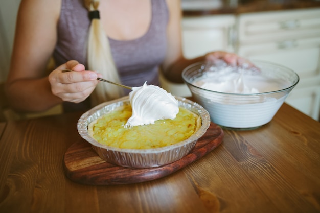 Close-up shot of a kitchen scene where a parent is grating zucchini into pancake batter, with a child curiously watching. The scene is bright and inviting, emphasizing the ease of incorporating vegetables.