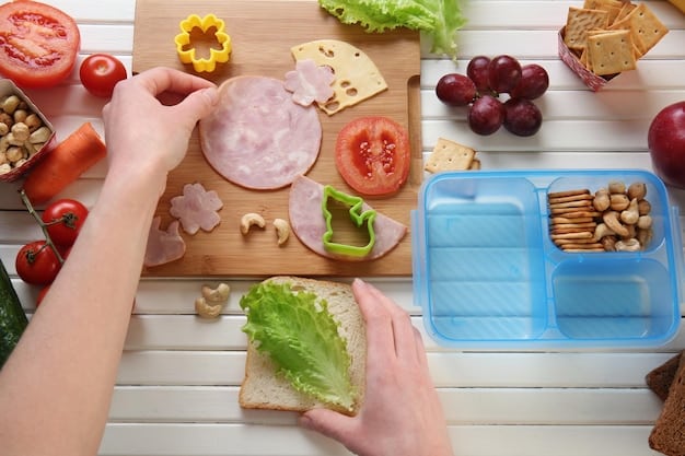 A person placing a slim ice pack on top of a sandwich inside a lunchbox. Sliced vegetables and fruits are neatly arranged around the sandwich, ensuring everything stays cool.