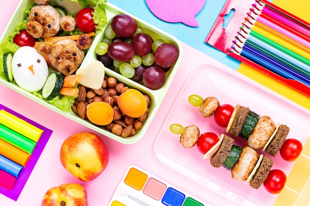 A set table with a colorful spread of kid-friendly food items, including cut fruits, vegetables, mini sandwiches, and a small glass of milk. The food is arranged neatly, and the atmosphere is inviting and stress-free.