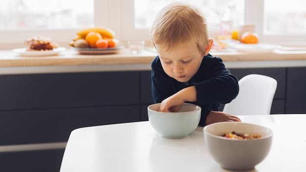 A toddler sitting at a small table, happily eating a bowl of overnight oats with fresh berries. The child is smiling and engaged with the food, and the setting is a bright, cheerful kitchen. The focus is on the toddler's enjoyment of the healthy breakfast, with a blurred background to keep the attention on the child and the meal.