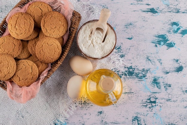 A close-up shot of various allergy-friendly baking ingredients, including gluten-free flour, almond milk, coconut oil, and flaxseed meal, arranged artfully on a wooden table. The focus is on the natural textures and colors of the ingredients, highlighting their wholesome nature.