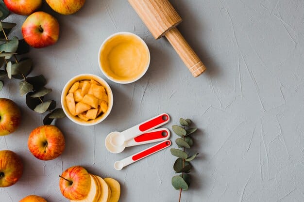 A well-organized kitchen counter displaying various tools for making homemade baby food, including a blender, steamer basket, ice cube trays filled with pureed fruits and vegetables, and small containers.