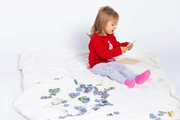 A bright, colorful image of a nine-month-old baby sitting on the floor, focused on a puzzle with large, easy-to-grasp pieces. The baby is actively trying to fit a piece into the puzzle.