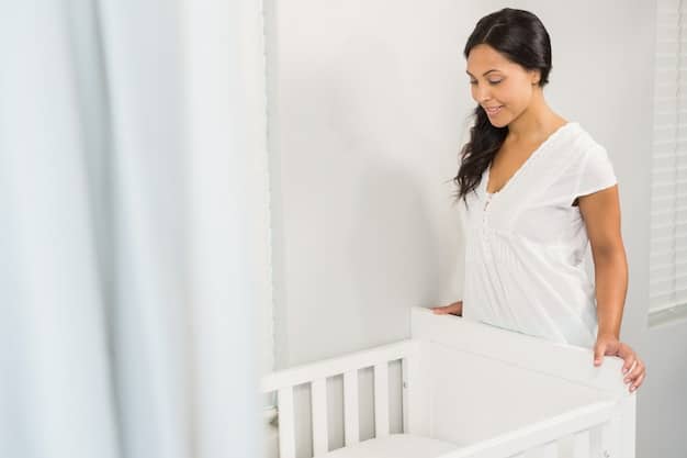 A mom carefully placing her baby on its back in a crib that has only a fitted sheet on the mattress.