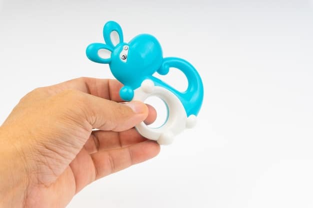 A brightly colored, BPA-free teething toy being held by a baby, with a slight frosty appearance to indicate it's been chilled. The baby is smiling slightly, showing signs of comfort.