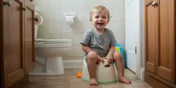 Toddler happily using a small potty with parental supervision in a US home.