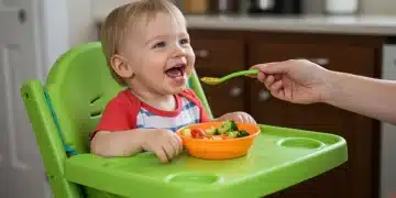 Happy toddler enjoying a healthy colorful meal in a high chair
