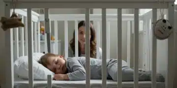 Peaceful toddler sleeping soundly in a crib after successful sleep training