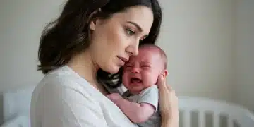 Mother comforting crying baby in a soft embrace